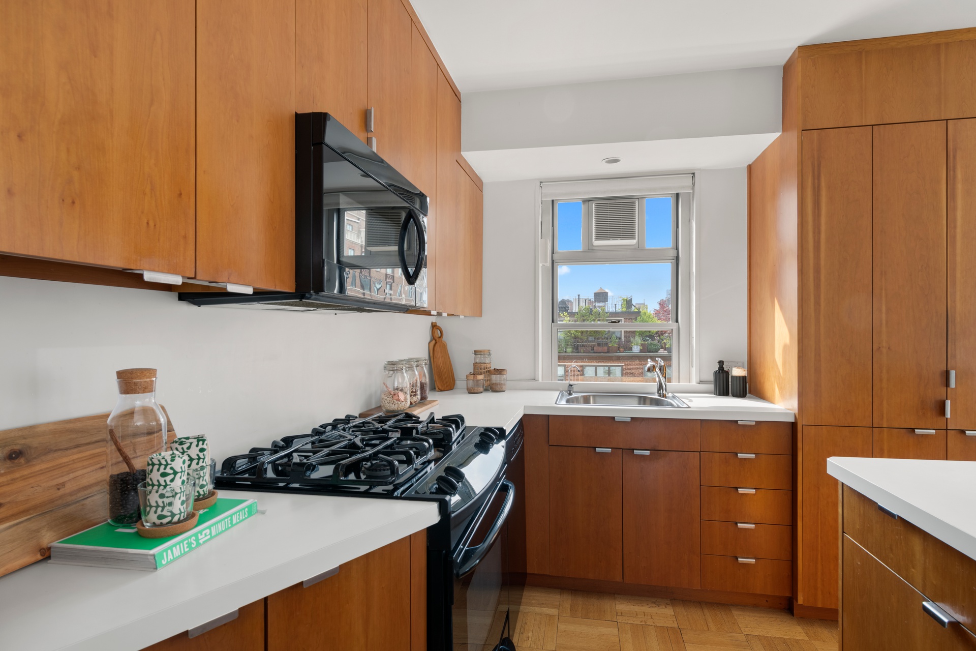 70 East 10th Street, Unit 15R Manhattan, NY 10003 - Photo 5 of 12 a kitchen with stainless steel appliances a stove a sink and a refrigerator