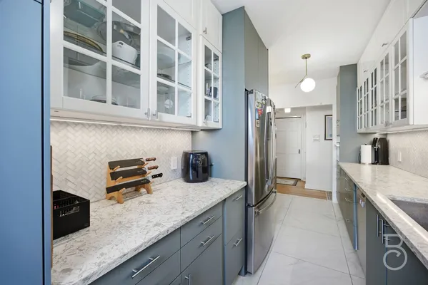 a kitchen with a stove and a refrigerator