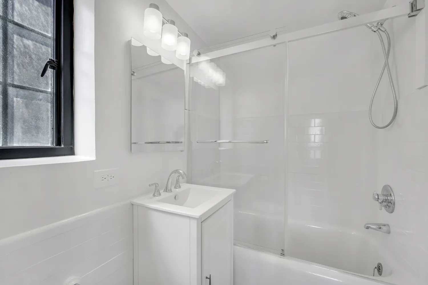 a bathroom with a bathtub a shower a sink and a vanity