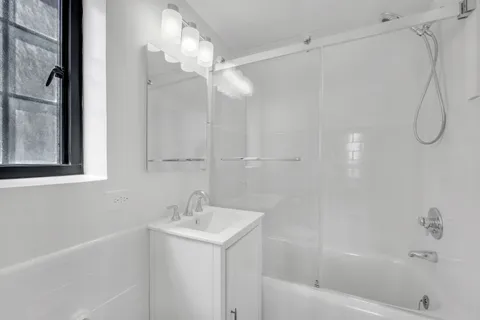 a bathroom with a bathtub a shower a sink and a vanity