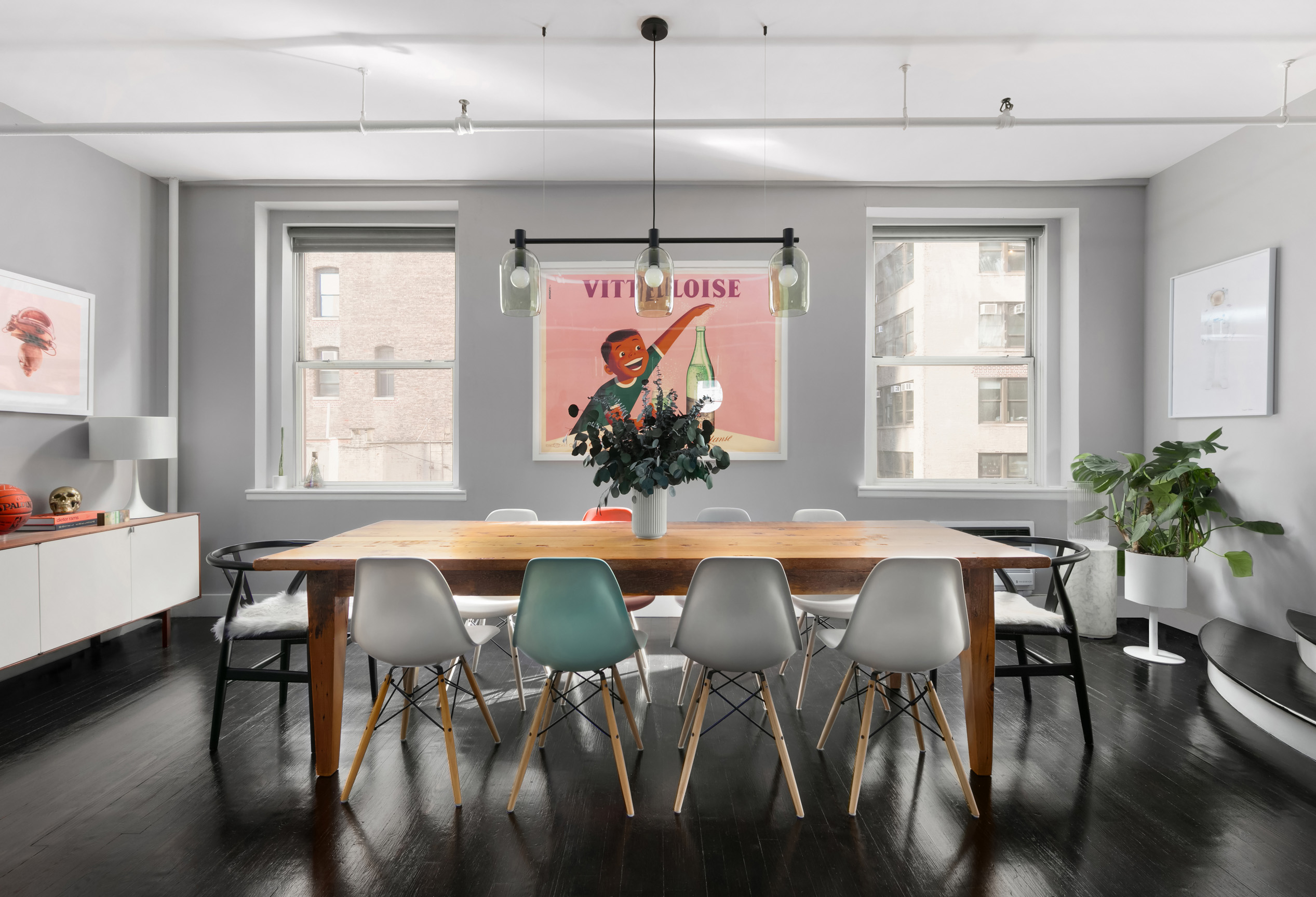 133-131 West 28th Street, Unit 6C Manhattan, NY 10001 - Photo 2 of 10 a dining room with furniture potted plants and wooden floor