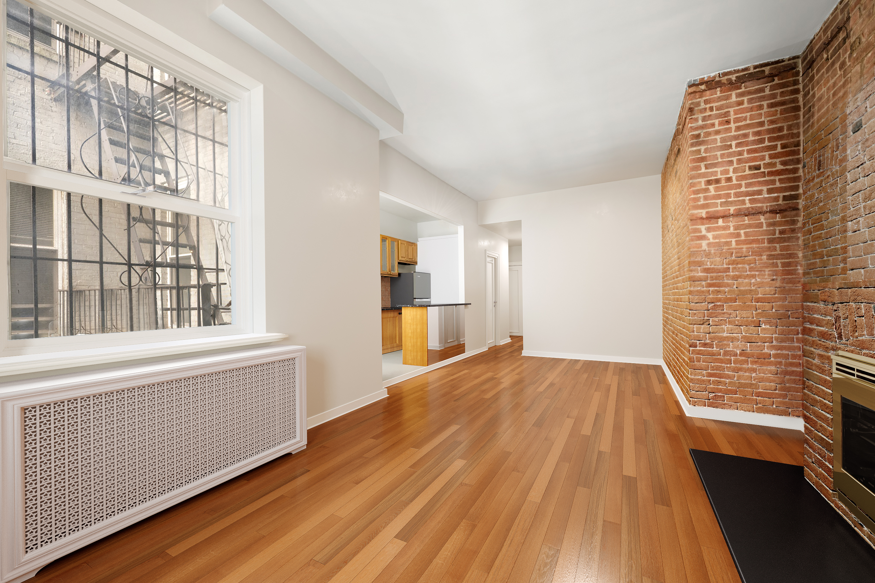305 West 55th Street, Unit 2B Manhattan, NY 10019 - Photo 4 of 9 a view of empty room with wooden floor and fan