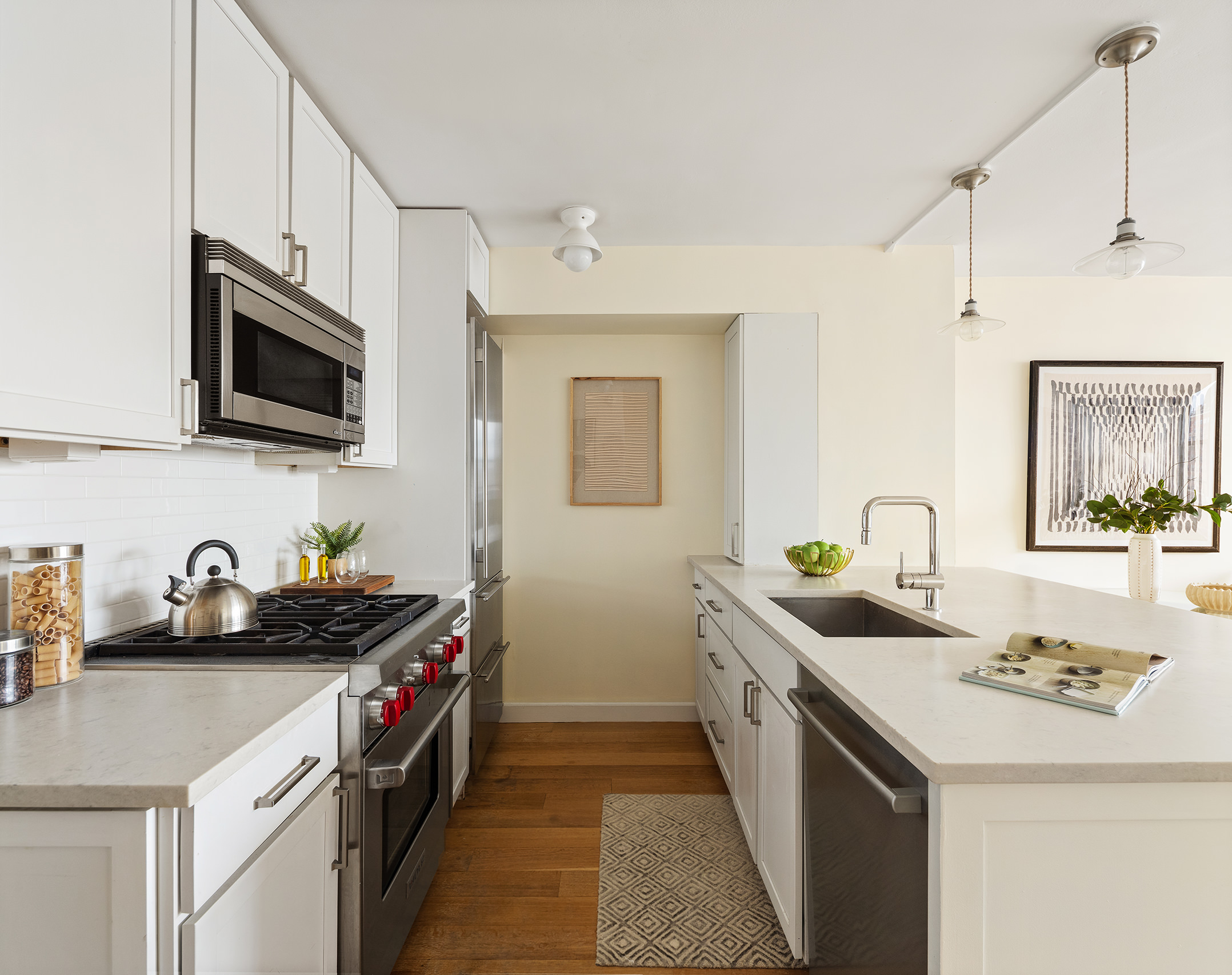61 Jane Street, Unit 19J Manhattan, NY 10014 - Photo 6 of 12 a kitchen that has a sink and a stove
