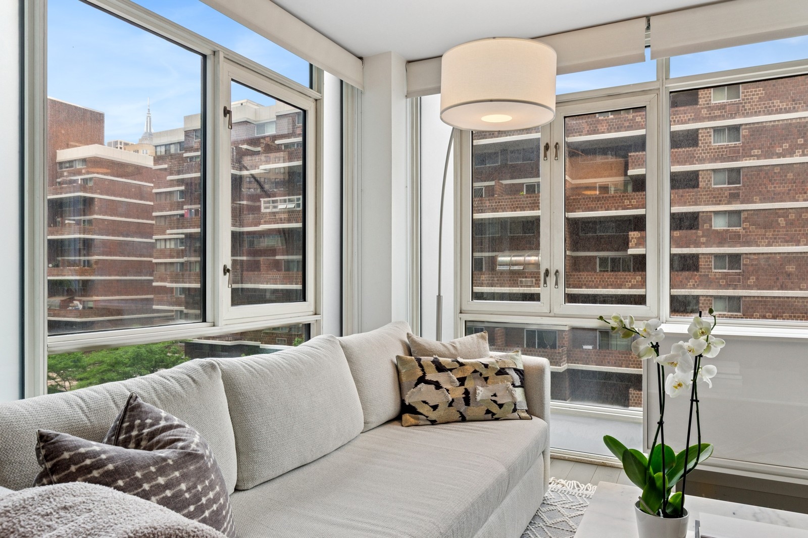 385 1st Avenue, Unit 6B Manhattan, NY 10010 - Photo 2 of 15 a living room with furniture and a large window
