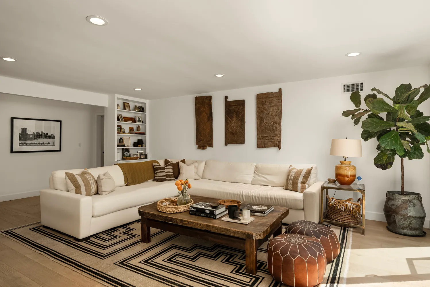 a living room with furniture a rug and a potted plant