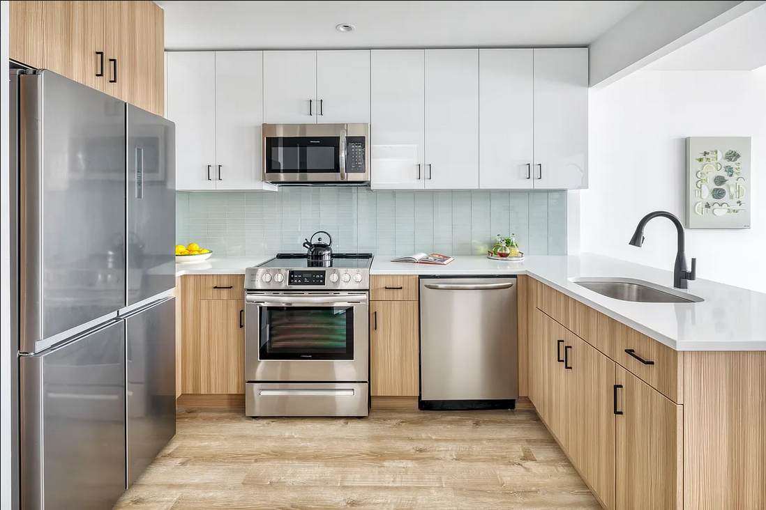 1425 Fulton Street, Unit 4A Brooklyn, NY 11216 - Photo 3 of 12 a kitchen with stainless steel appliances granite countertop a sink a stove a refrigerator and cabinets