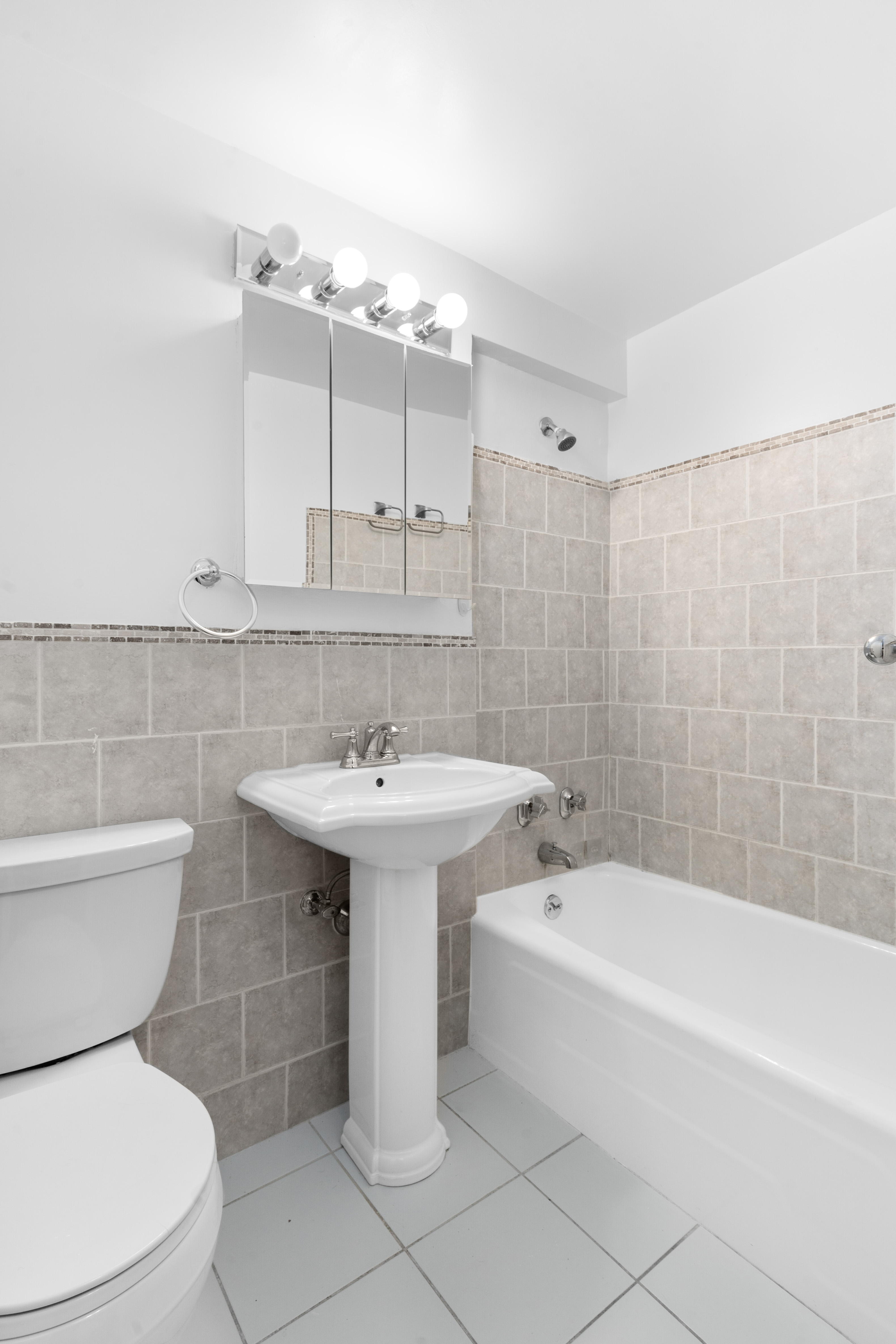 101 West 12th Street, Unit 3Z Manhattan, NY 10011 - Photo 5 of 7 a bathroom with a sink toilet and shower