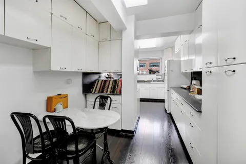 a kitchen with stainless steel appliances cabinets a sink and a refrigerator