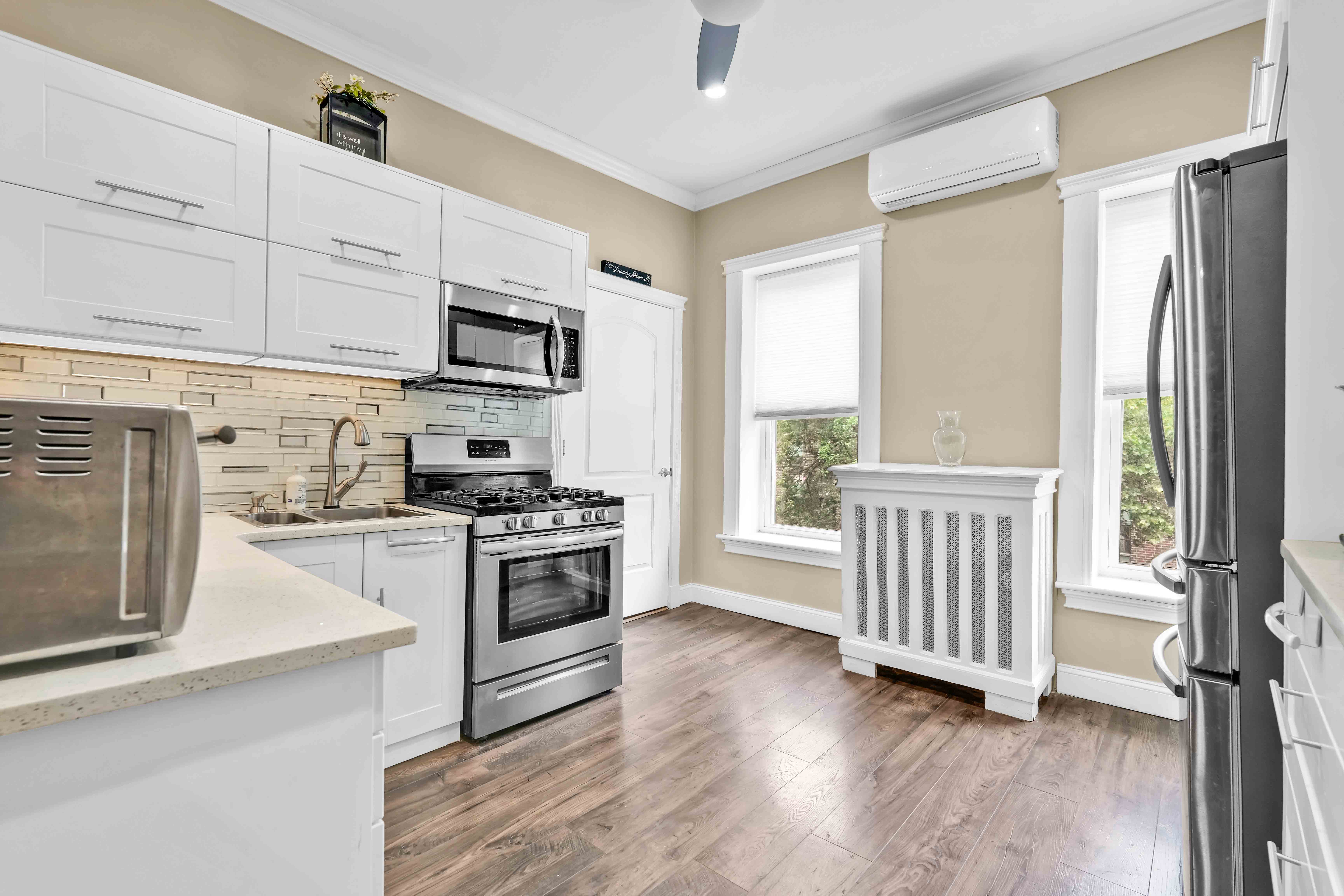 519 Monroe Street Brooklyn, NY 11221 - Photo 11 of 55 a kitchen with stainless steel appliances granite countertop a stove a sink and a refrigerator