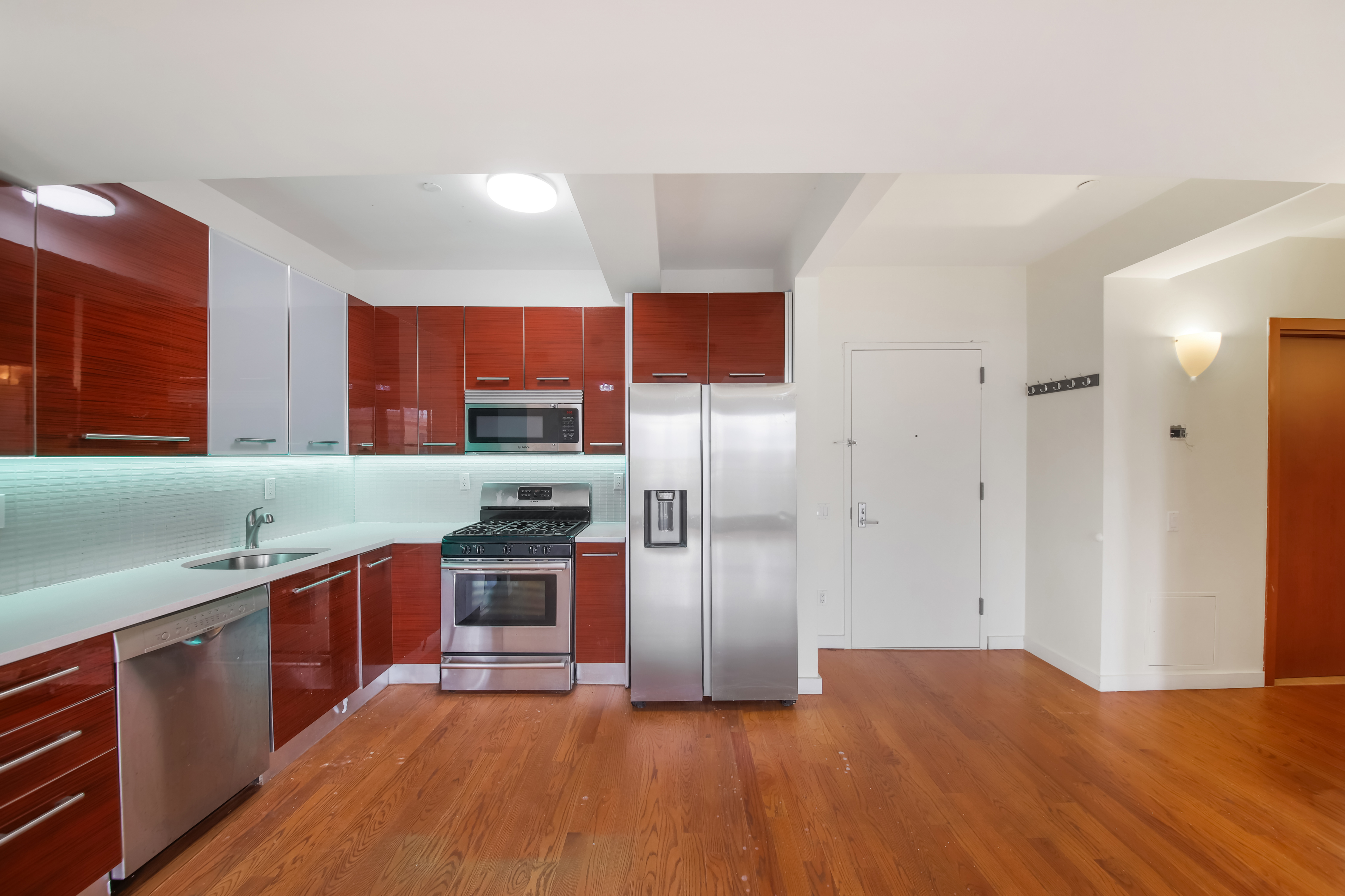 3112 Emmons Avenue, Unit 206 Brooklyn, NY 11235 - Photo 8 of 10 a kitchen with stainless steel appliances granite countertop a refrigerator and a sink