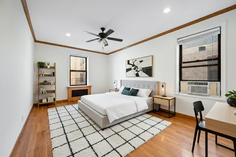 a bedroom with a large bed and a window