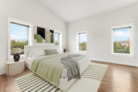a bedroom with a large bed and a large window