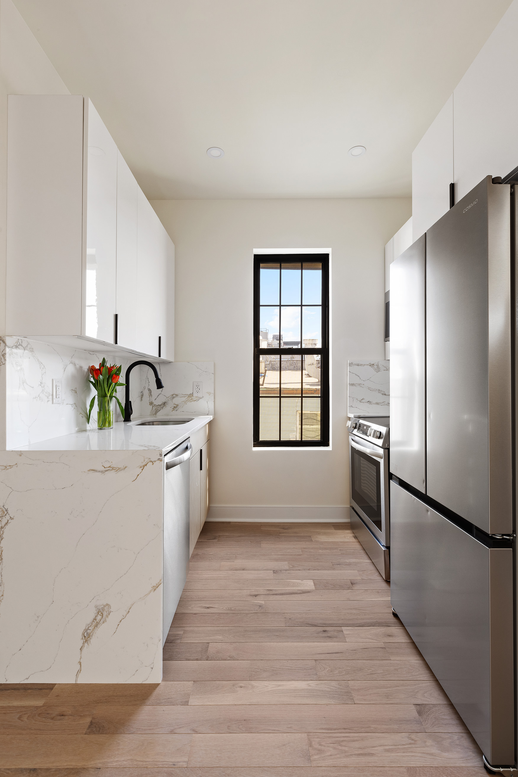 152 North 10th Street, Unit 2L Brooklyn, NY 11249 - Photo 4 of 12 a kitchen with stainless steel appliances a refrigerator sink and cabinets