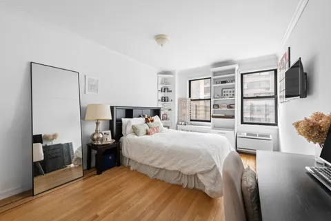a bedroom with a bed and flat screen tv