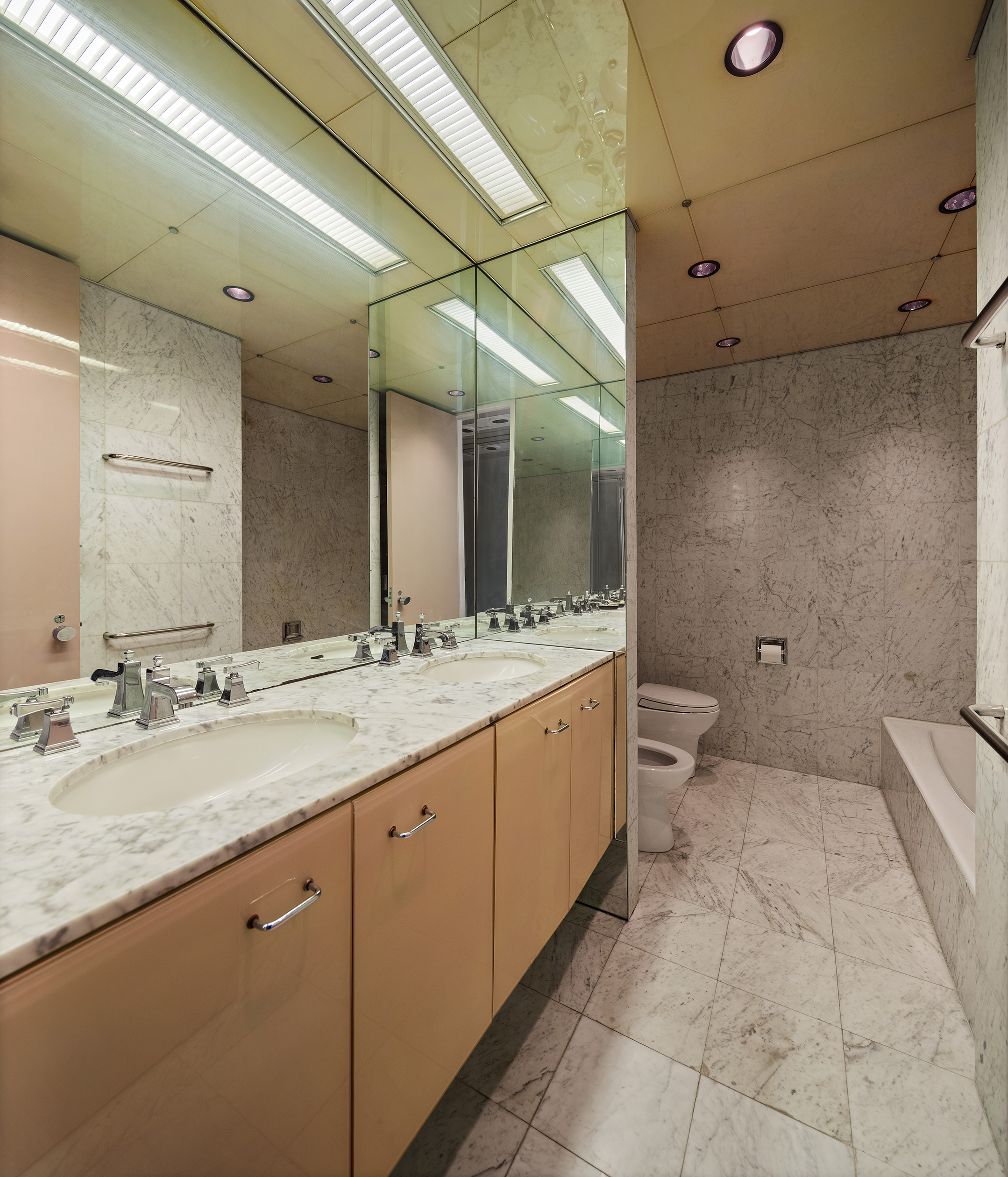 415 East 54th Street, Unit 2A Manhattan, NY 10022 - Photo 9 of 16 a bathroom with a granite countertop sink mirror and toilet