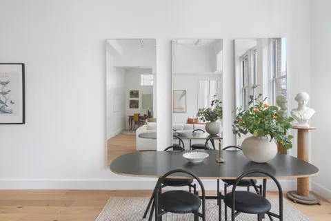 a dining room with furniture and wooden floor