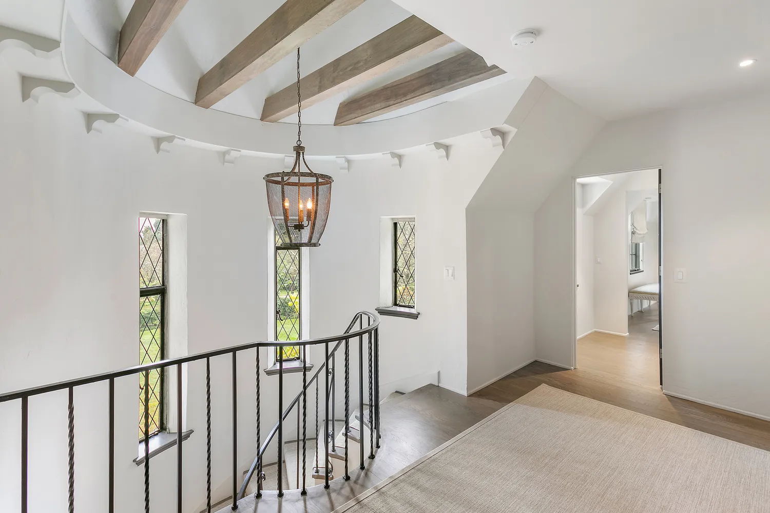 a view of hallway with wooden floor