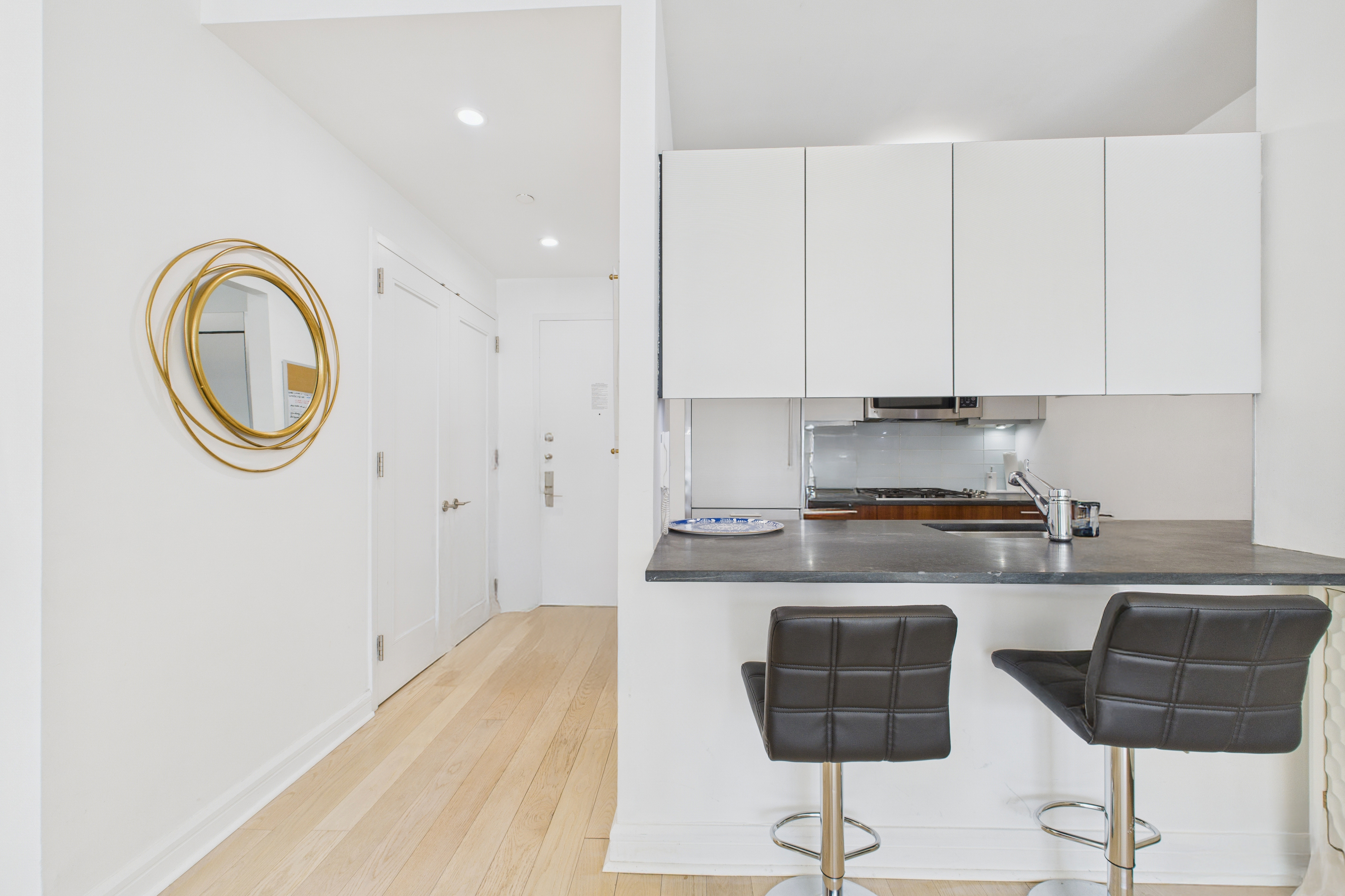 100 Riverside Boulevard, Unit 12B Manhattan, NY 10069 - Photo 5 of 10 a kitchen with stainless steel appliances granite countertop a stove a sink and a white cabinets