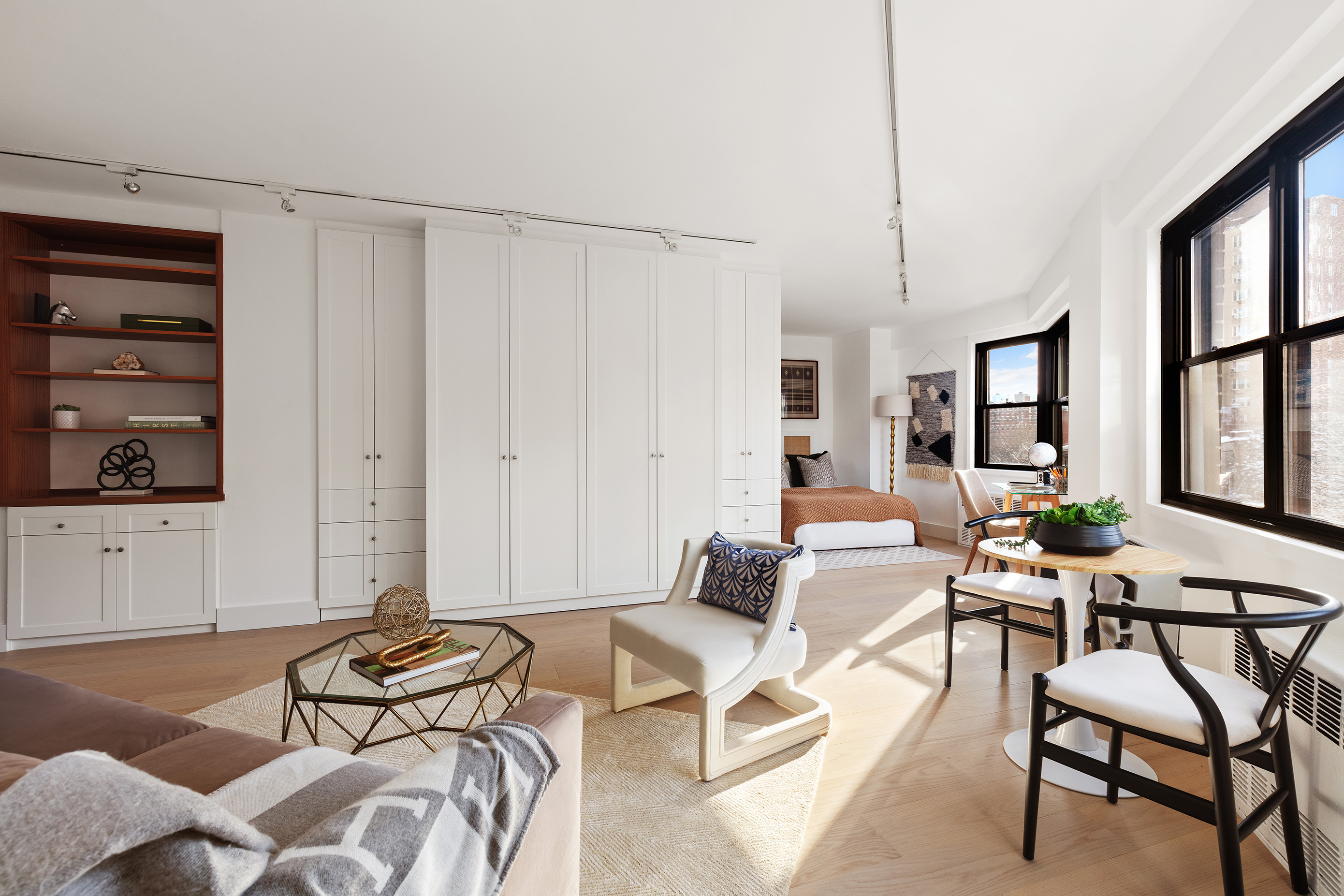 31 Jane Street, Unit 5A Manhattan, NY 10014 - Photo 2 of 13 a living room with furniture a rug and white walls