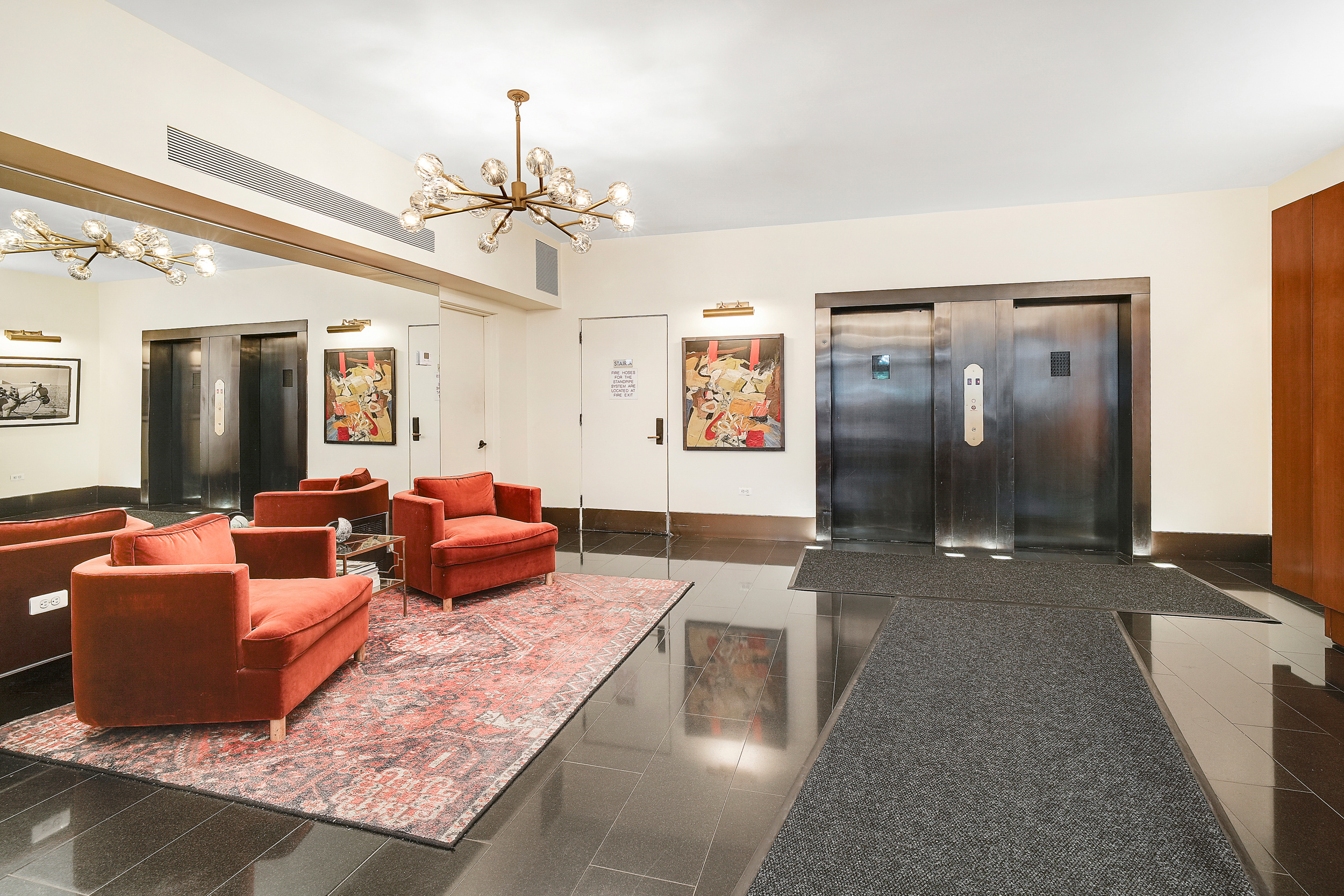 135 East 54th Street, Unit 12M Manhattan, NY 10022 - Photo 8 of 10 a living room with furniture and a chandelier
