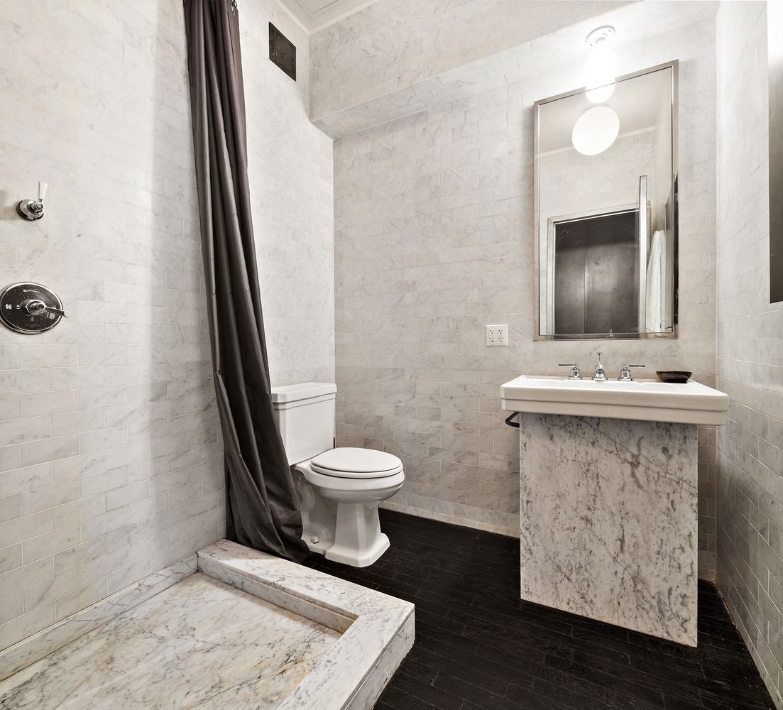 366 Broadway, Unit 5C Manhattan, NY 10013 - Photo 15 of 18 a bathroom with a toilet sink and mirror