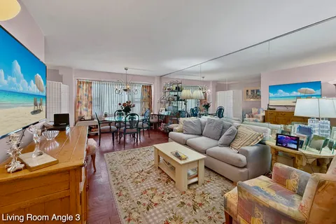 a living room with furniture wooden floor and a flat screen tv