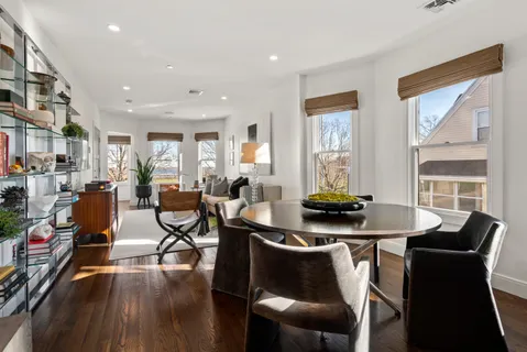 a room with furniture a large window and wooden floor