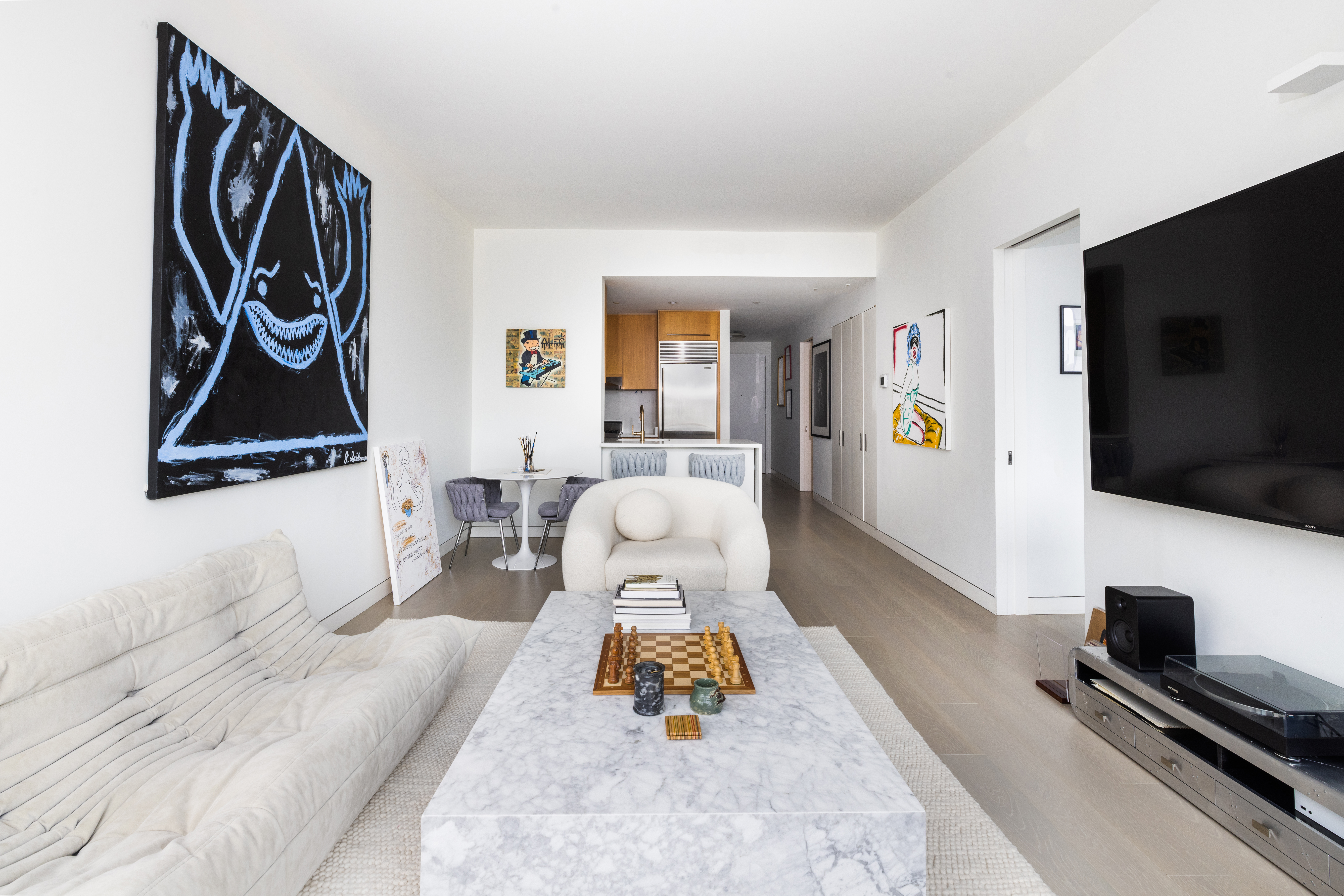 255 Hudson Street, Unit 9C Manhattan, NY 10013 - Photo 6 of 19 a living room with furniture and a flat screen tv