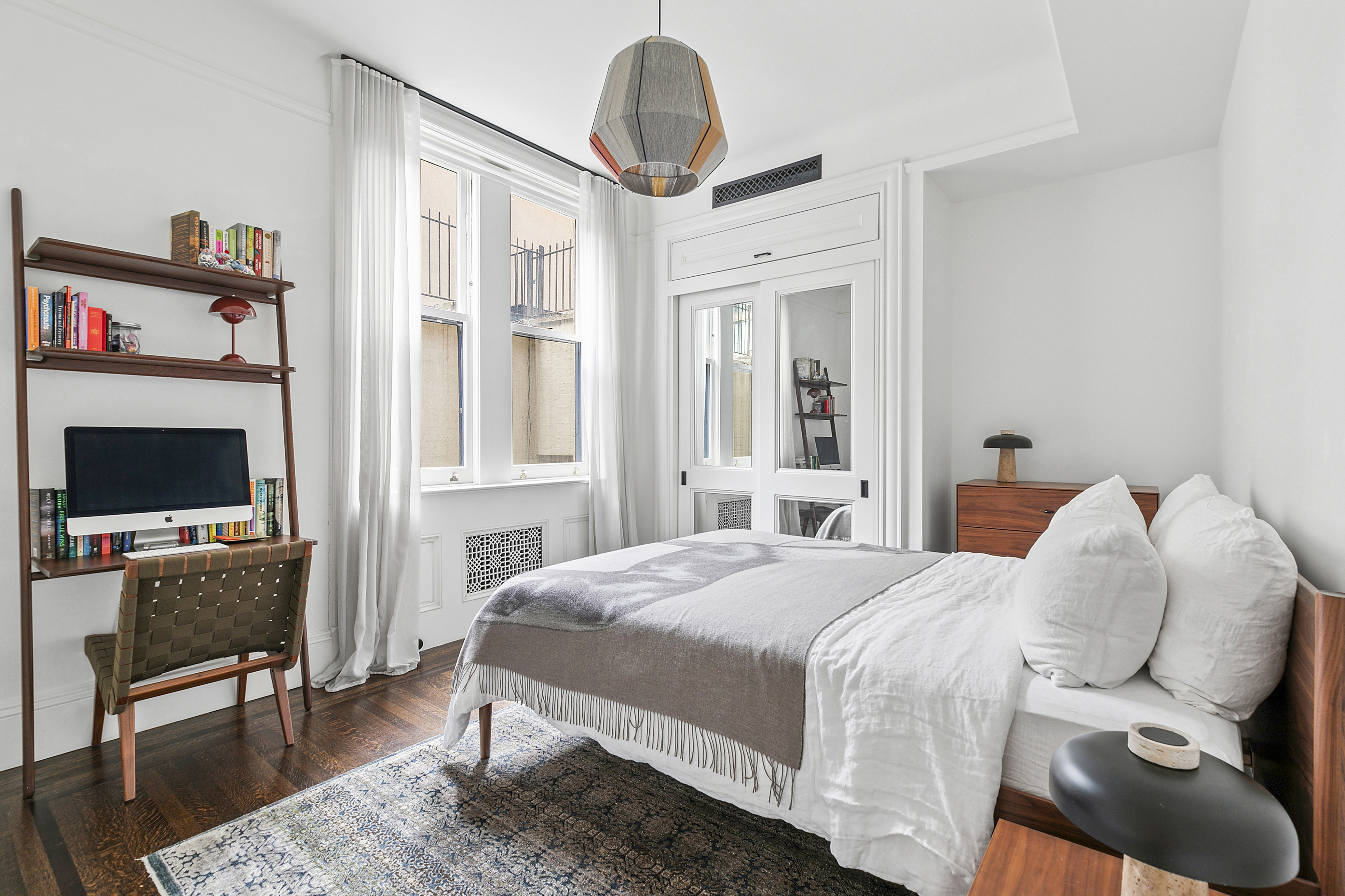 31 West 12th Street, Unit 5E Manhattan, NY 10011 - Photo 12 of 14 a bedroom with a bed and a flat screen tv