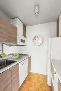 a kitchen with a sink a stove and cabinets