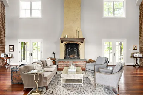 a living room with furniture a fireplace and a table