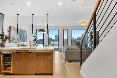 a view of living room with granite countertop furniture and a flat screen tv