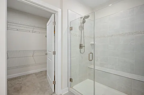 a bathroom with a glass shower door