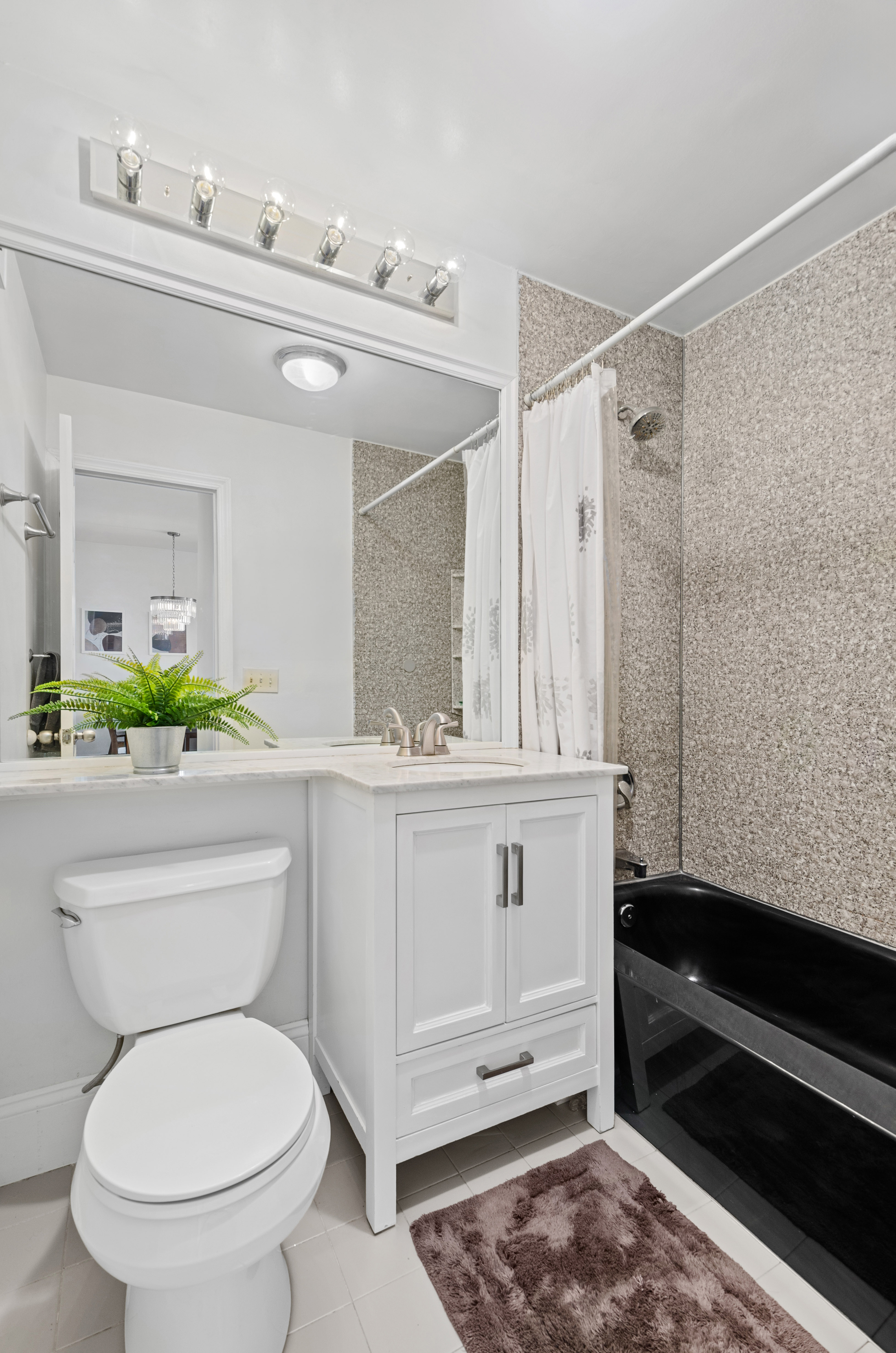 412 7th Avenue, Unit 2R Brooklyn, NY 11215 - Photo 7 of 9 a bathroom with a toilet a sink and a mirror