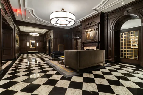 a room with black and white checkered floor with a black white checkered floor