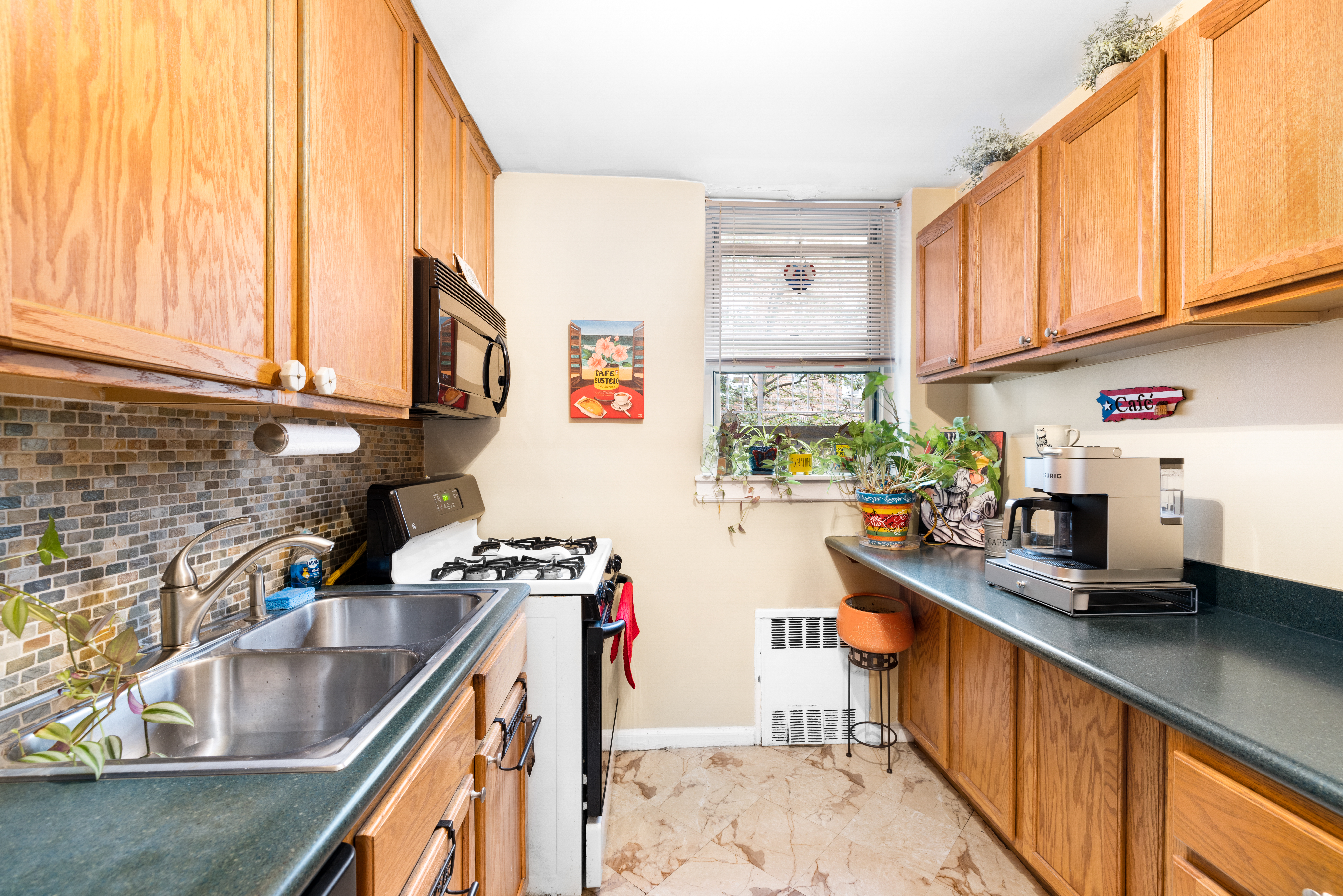 a kitchen with stainless steel appliances granite countertop sink stove and cabinets
