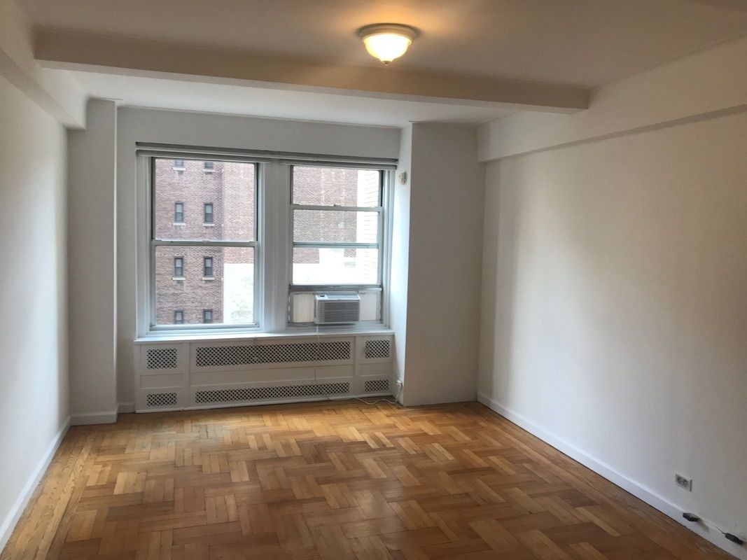 433 West 34th Street, Unit 6H Manhattan, NY 10001 - Photo 2 of 8 a view of room with window and front door