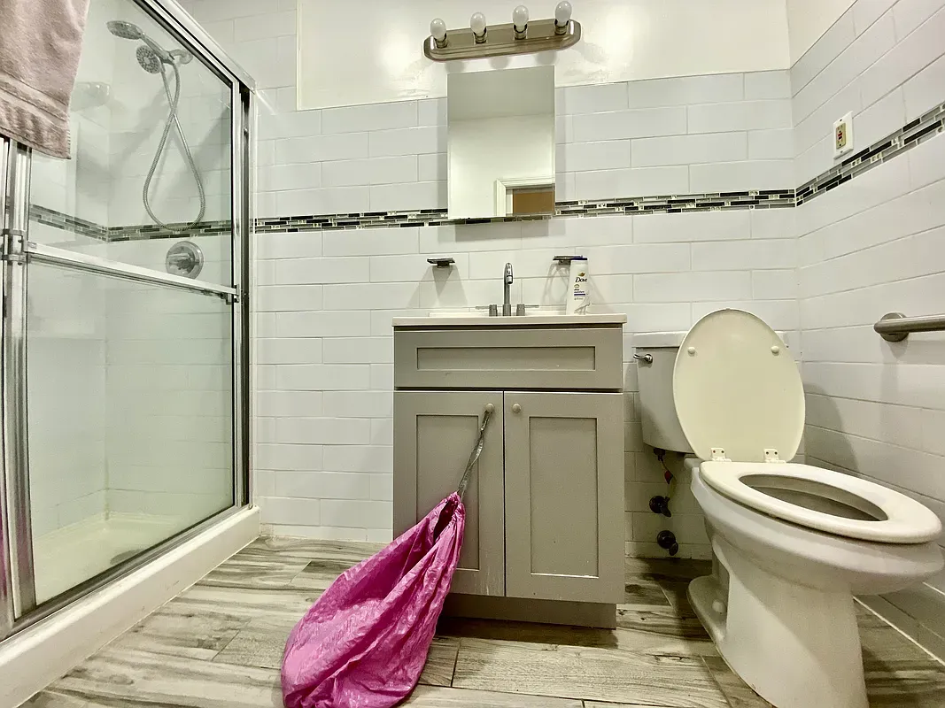 a bathroom with a toilet sink and shower