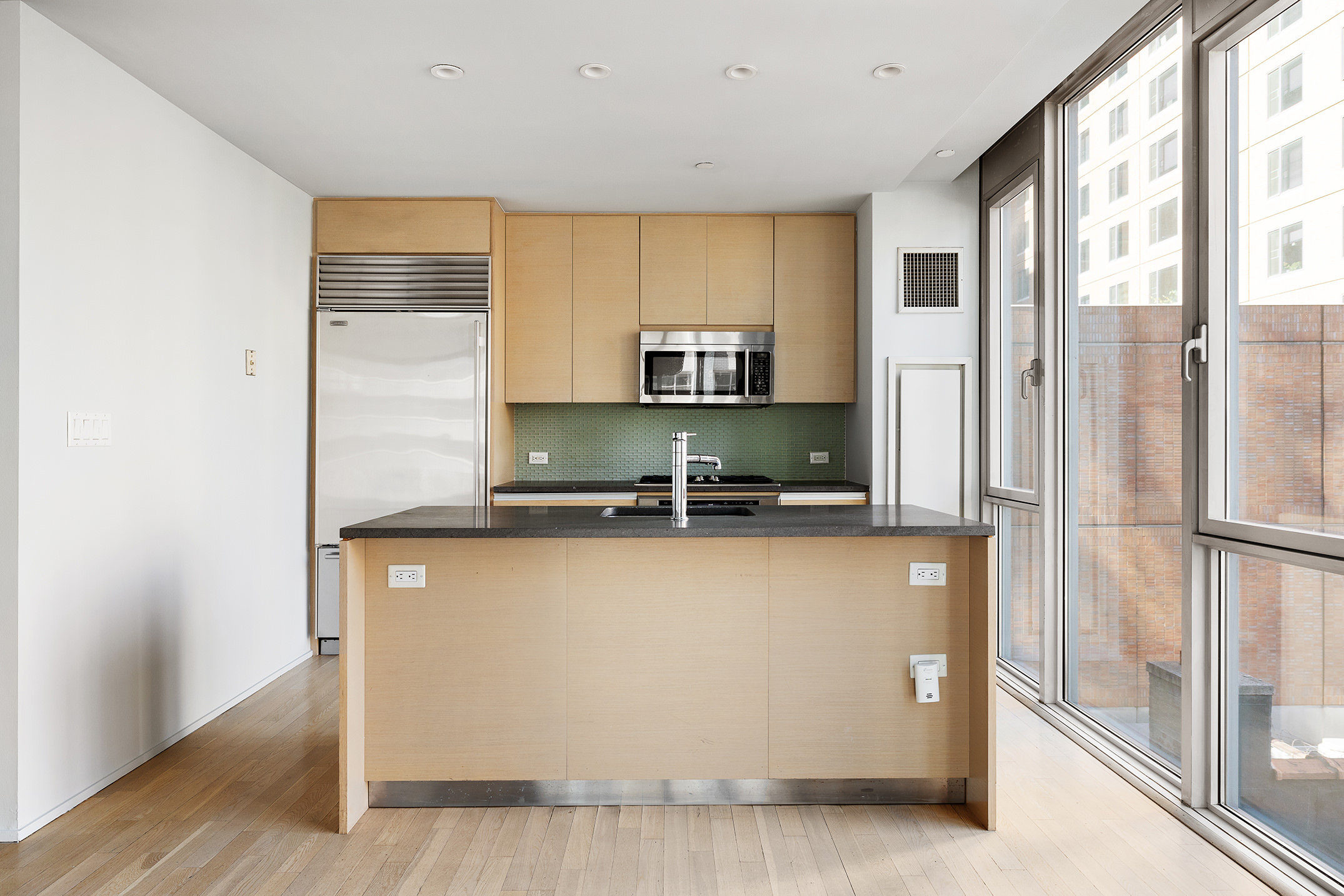 110 3rd Avenue, Unit 4C Manhattan, NY 10003 - Photo 4 of 17 a kitchen with stainless steel appliances a sink stove and a refrigerator