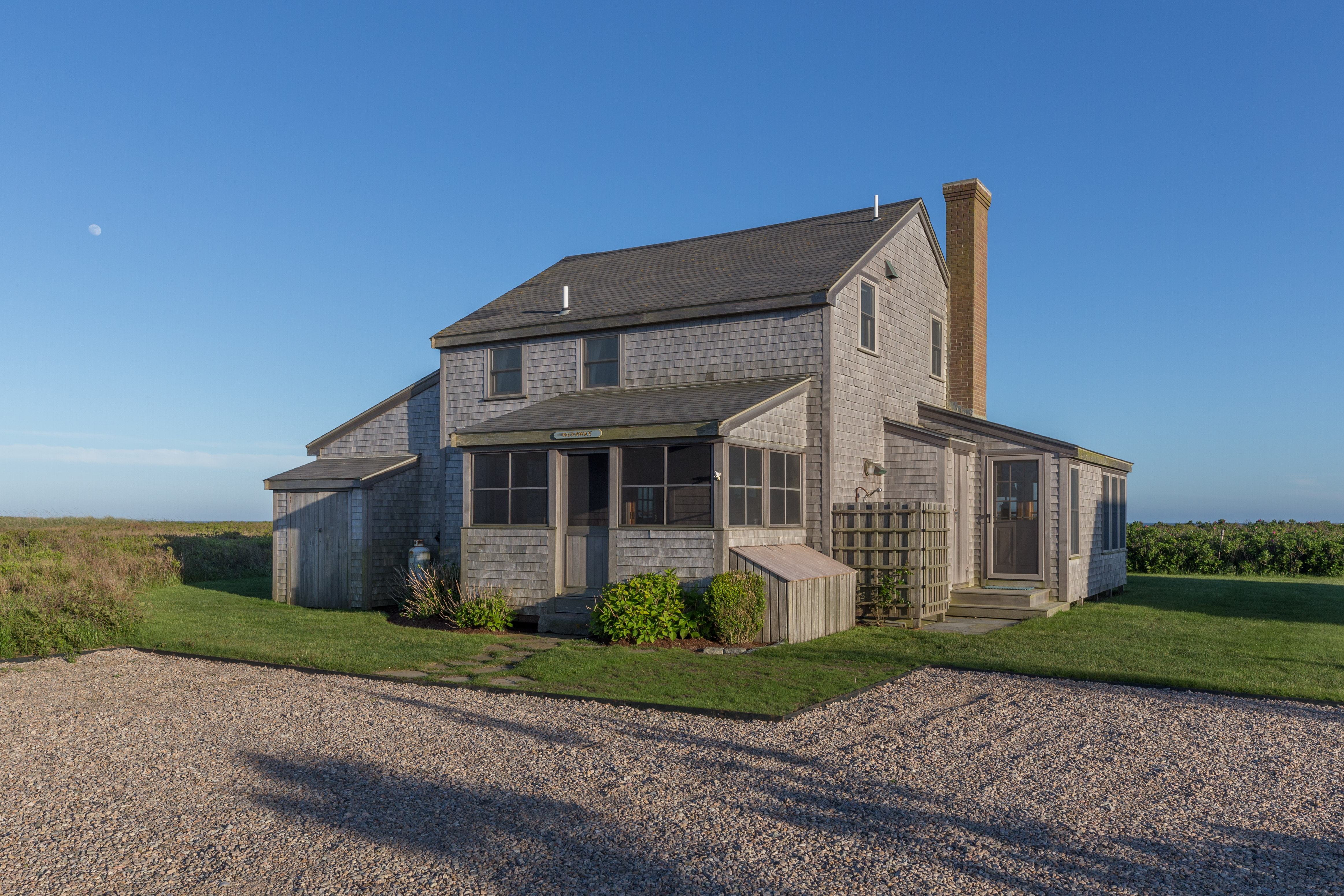 65 Nobadeer Avenue Nantucket, MA 02554 - Photo 2 of 20 a front view of a house with a garden