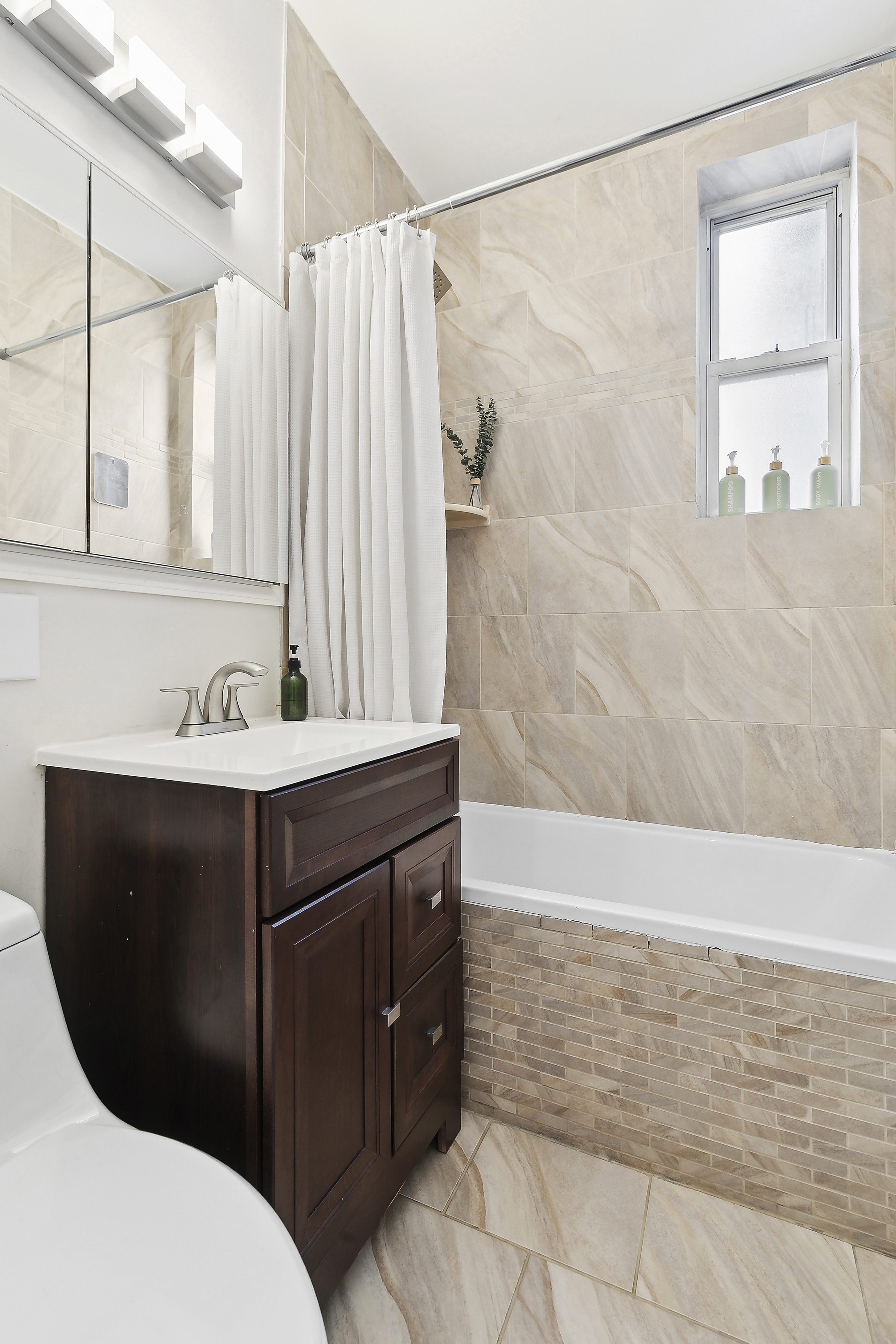 406 West 46th Street, Unit 4C Manhattan, NY 10036 - Photo 6 of 9 a bathroom with a sink vanity and a mirror