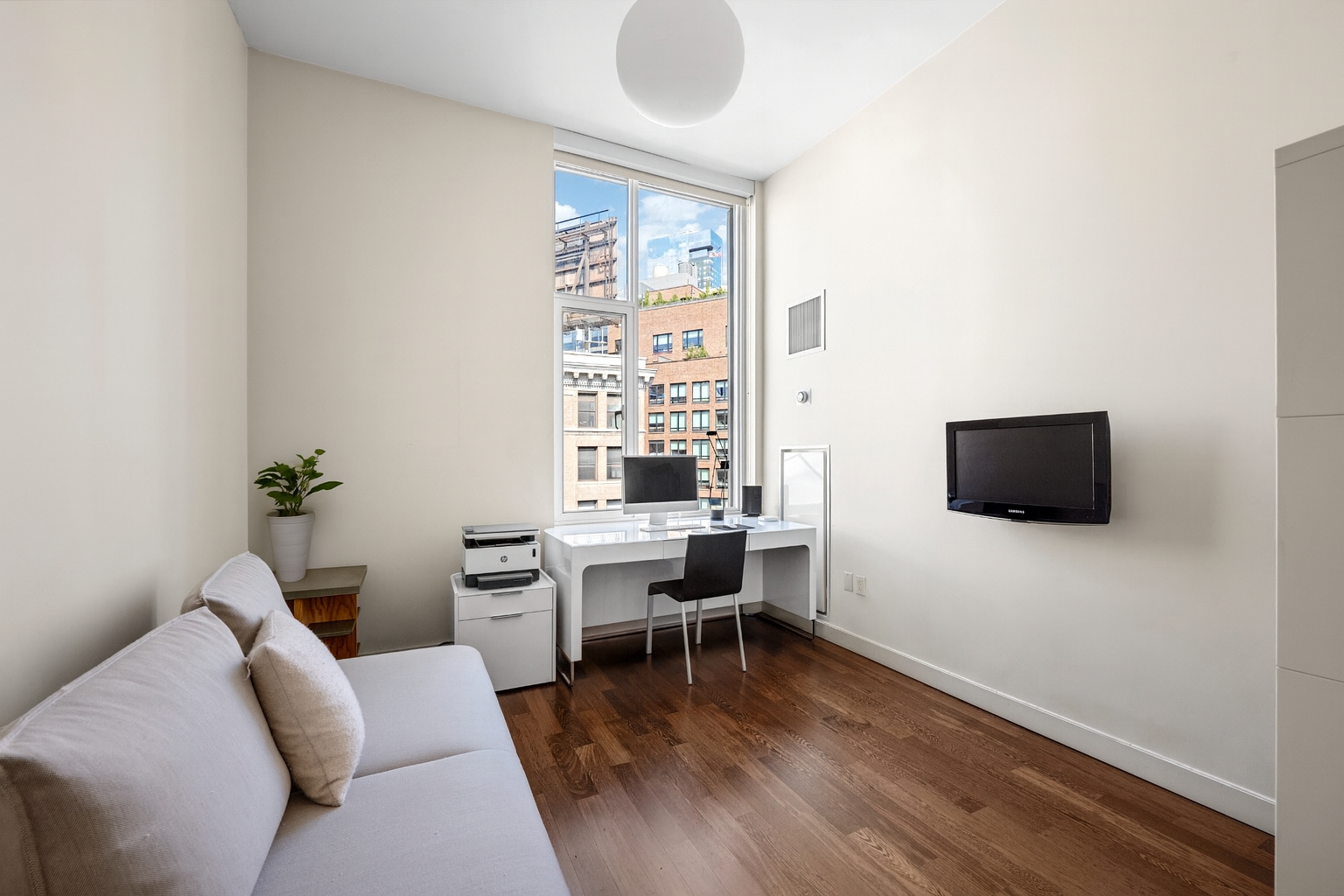 475 Greenwich Street, Unit 5B Manhattan, NY 10013 - Photo 10 of 16 a living room with furniture and a flat screen tv