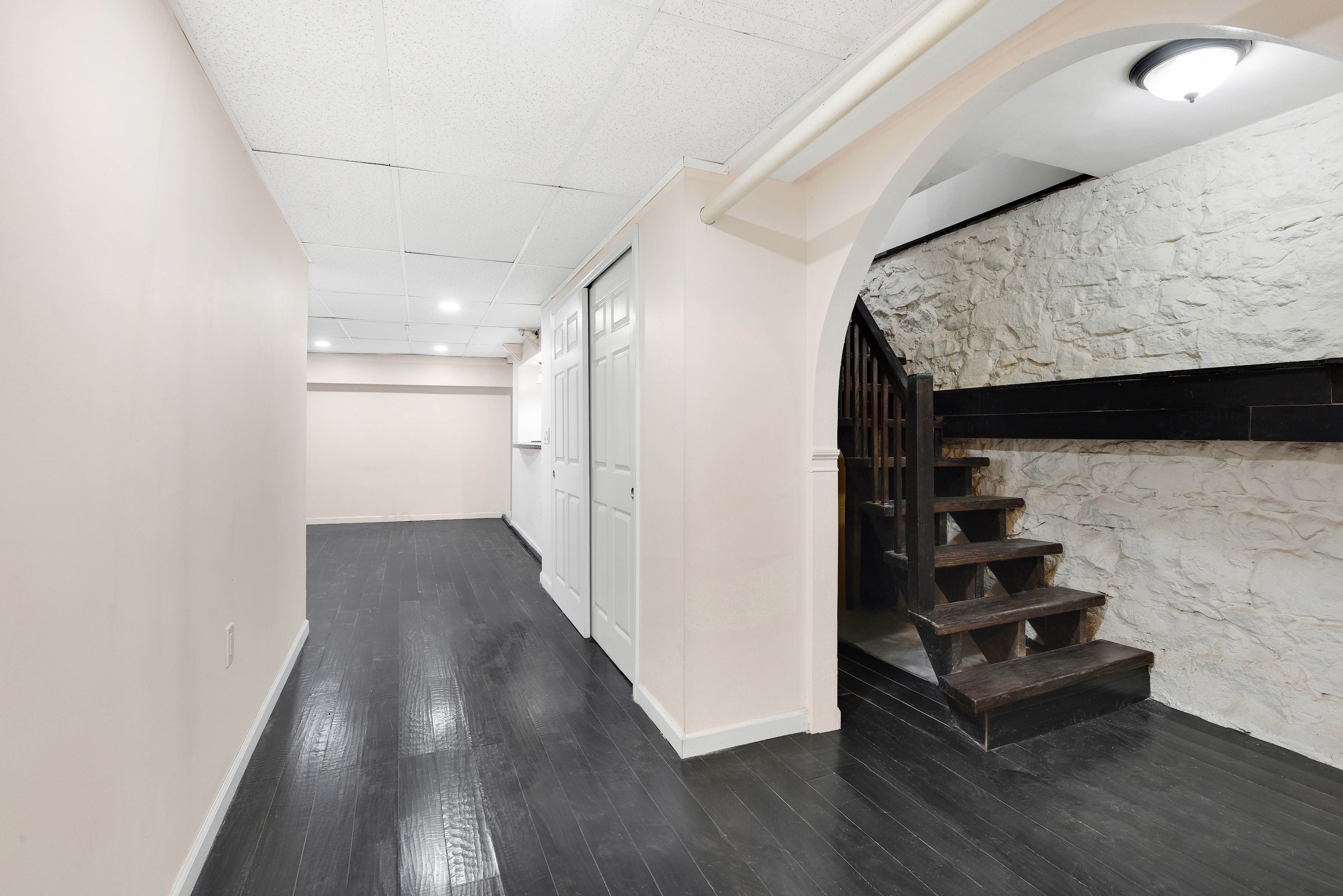 615 Willoughby Avenue, Unit 1 Brooklyn, NY 11206 - Photo 11 of 13 a view of a hallway with wooden floor and stairs