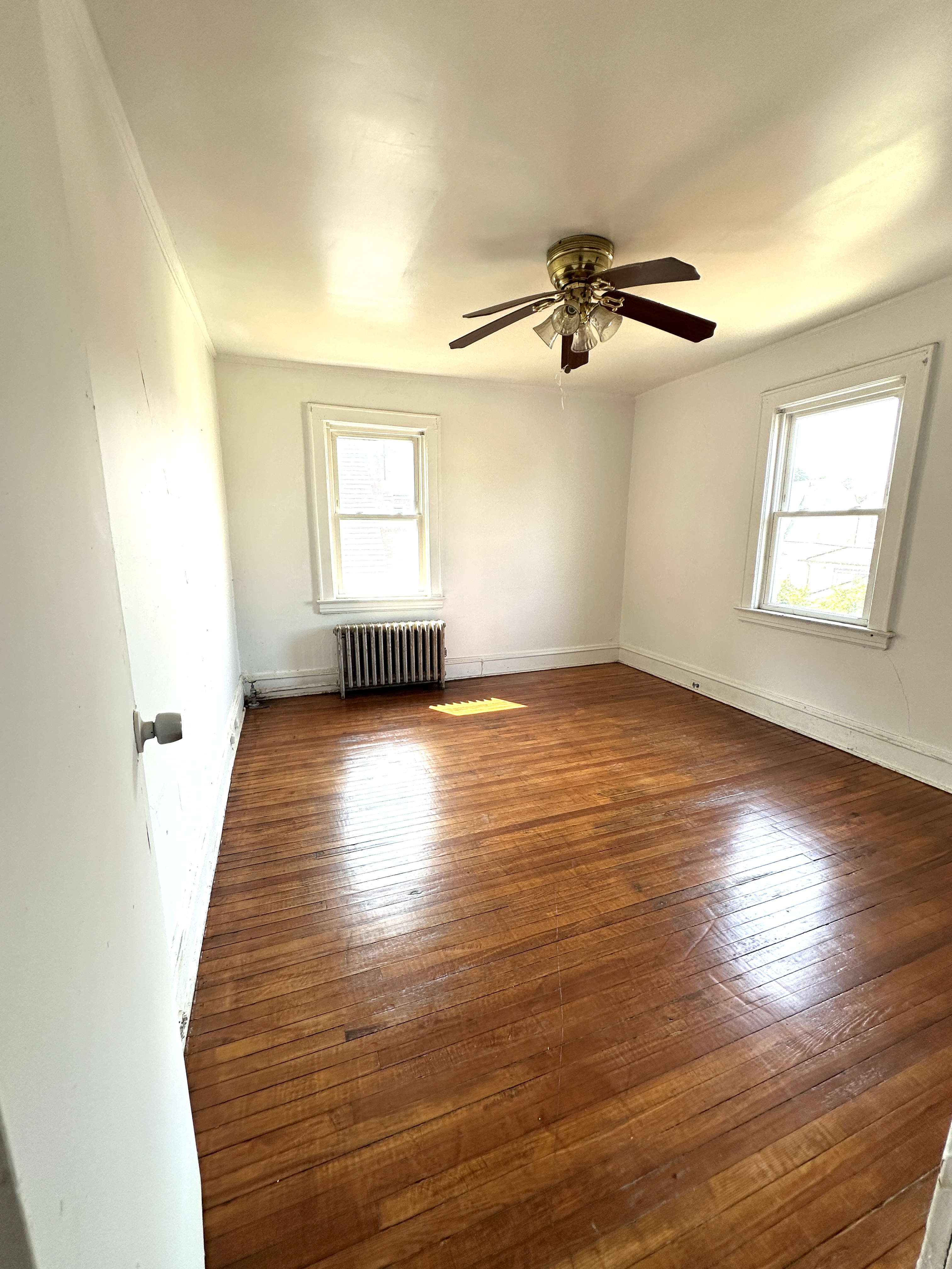 92-64 Springfield Boulevard Queens, NY 11428 - Photo 16 of 25 wooden floor in an empty room with a window
