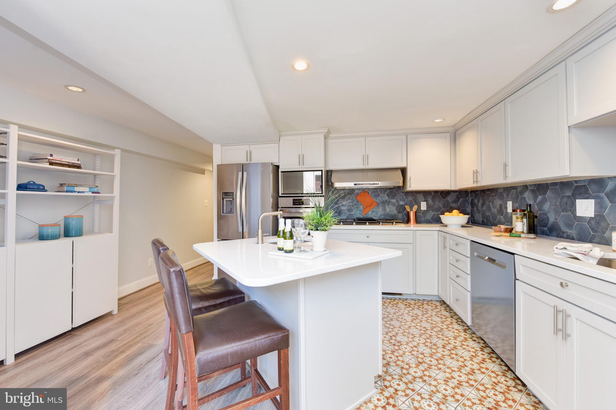 629 5th Street Northeast Washington, DC 20002 - Photo 10 of 31 a kitchen with white cabinets and white appliances