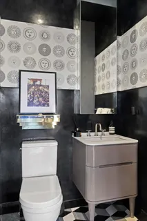 a bathroom with a toilet a sink and a mirror