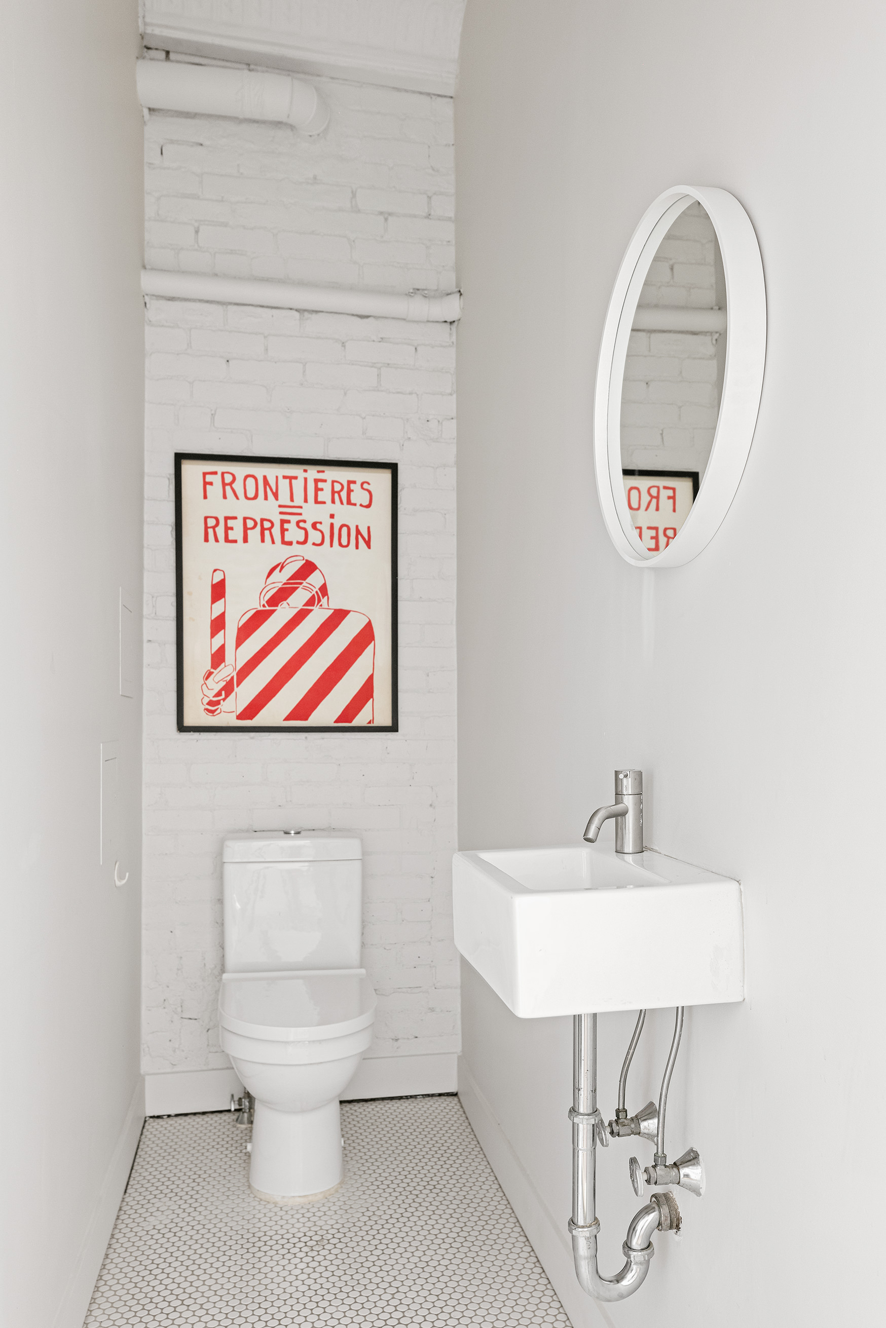 22 East 18th Street, Unit PH6B Manhattan, NY 10003 - Photo 9 of 13 a bathroom with a toilet a sink and mirror