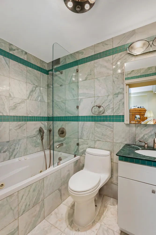 a bathroom with a toilet a sink and shower