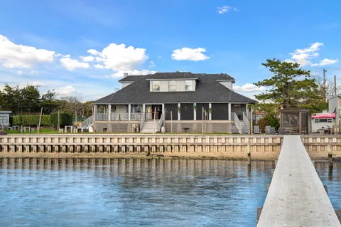 a view of swimming pool with outdoor seating and ocean view