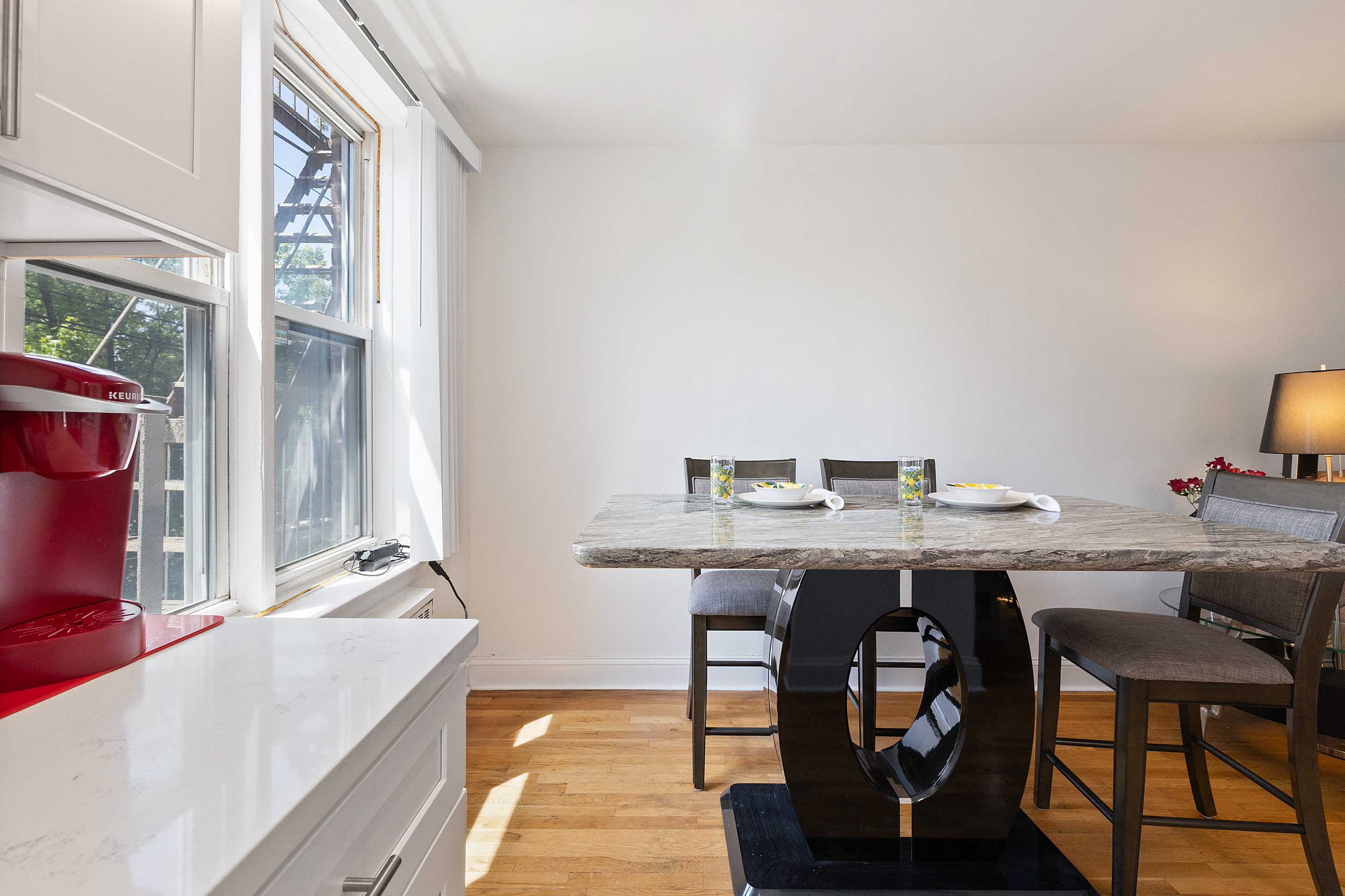 205 East 238th Street, Unit 2C Bronx, NY 10470 - Photo 4 of 14 a view of a kitchen area with furniture and wooden floor
